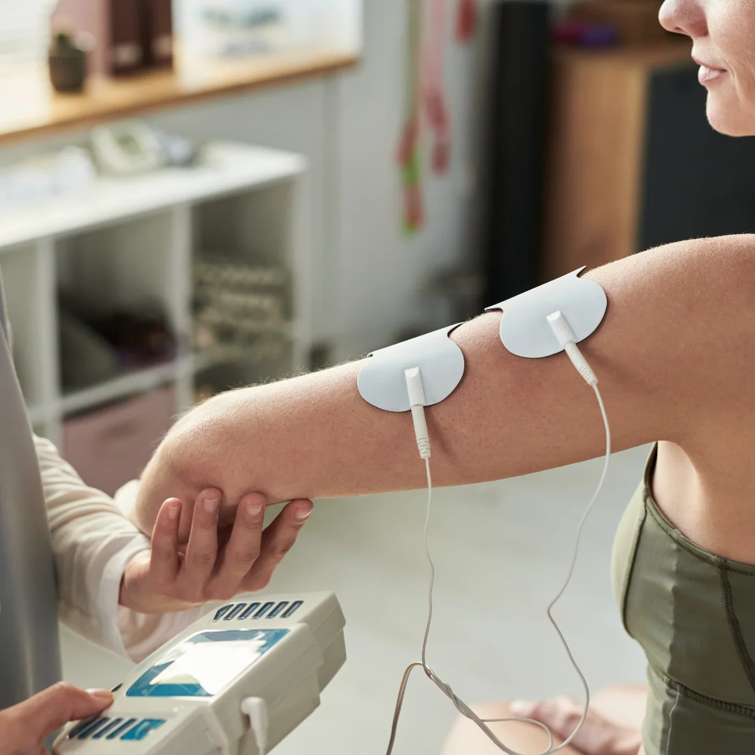 A physiotherapist massaging a patient knee joint during a rehabilitation session.