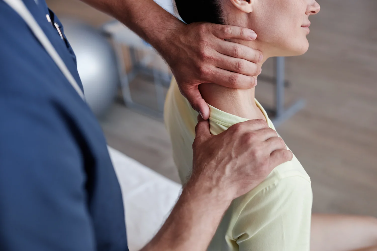 A physiotherapist performing hands-on manual therapy on a patient's arm.
